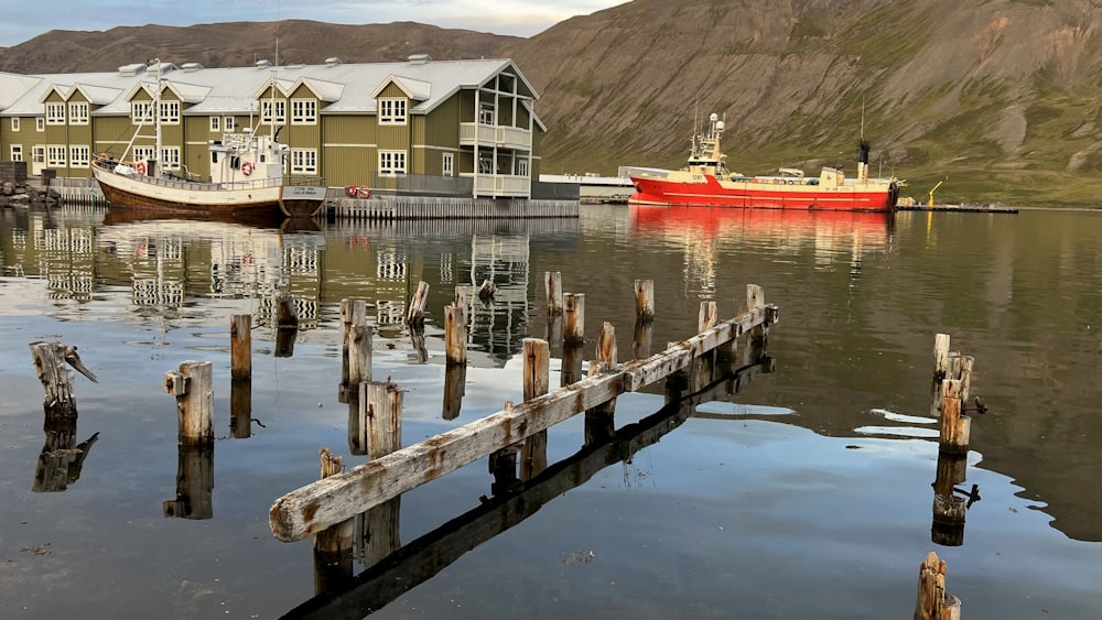 a boat is docked in the water next to a dock