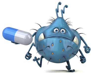 An anthropomorphic cartoon germ character with a blue body, exaggerated facial features, and orange spots, humorously depicted holding a large blue and white capsule pill.