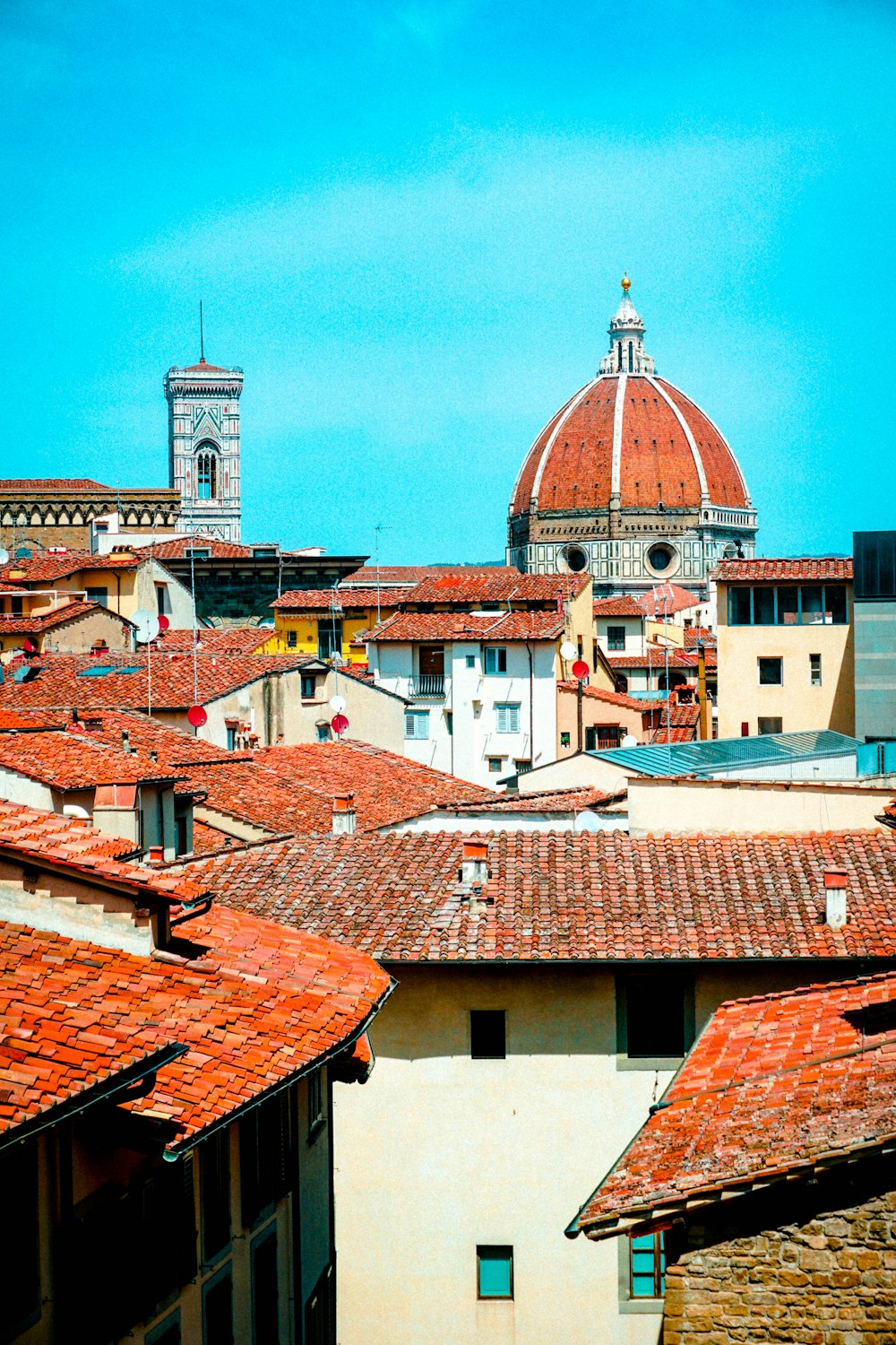 a view of rooftops with a dome in the background