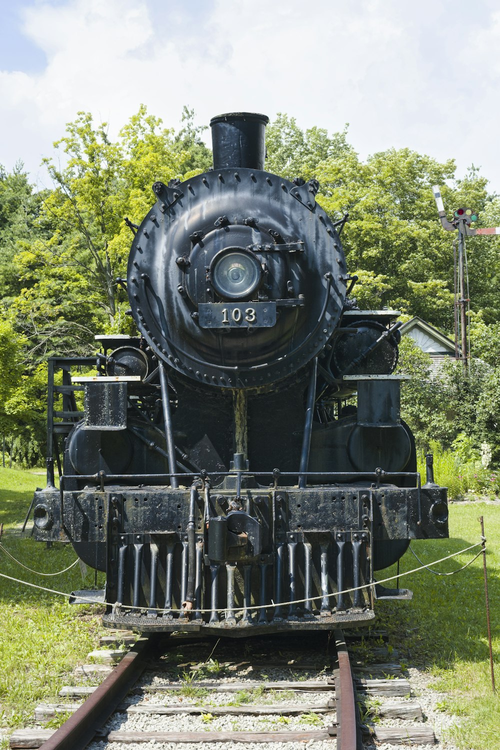 a black train engine sitting on the tracks