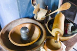 Various wooden spoons and rolling pins neatly displayed on a rustic kitchen counter