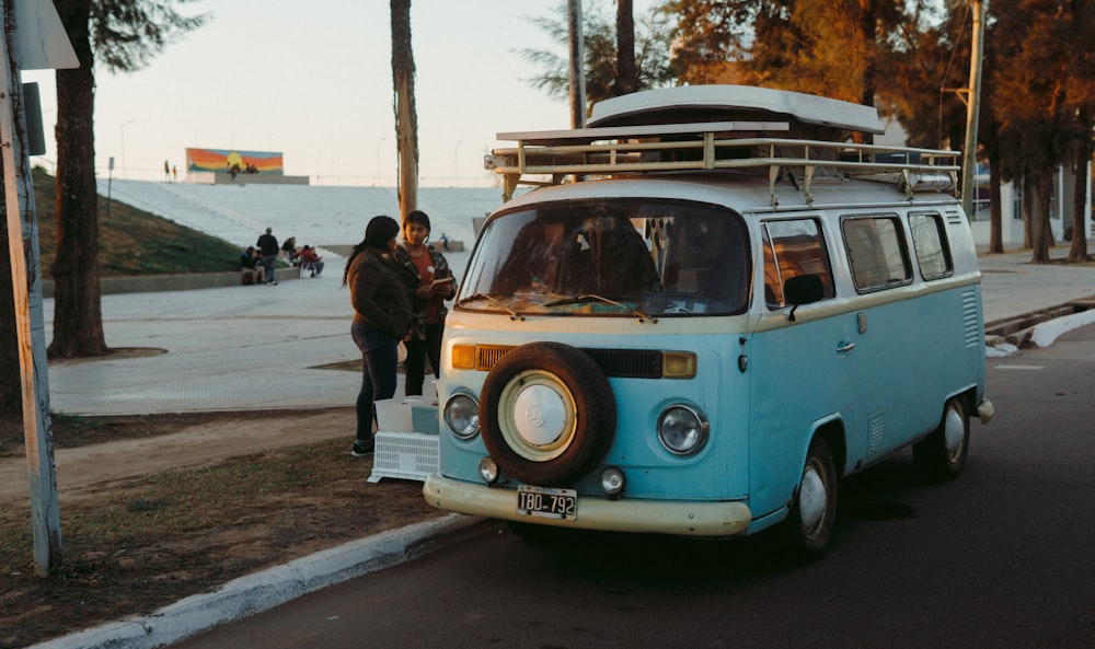 a blue and white van parked on the side of a road