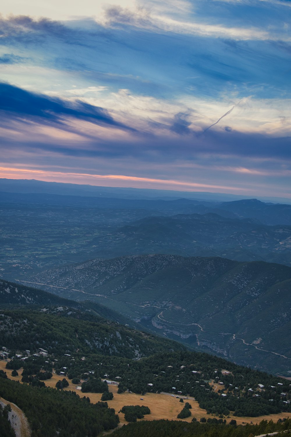 a scenic view of a valley and mountains