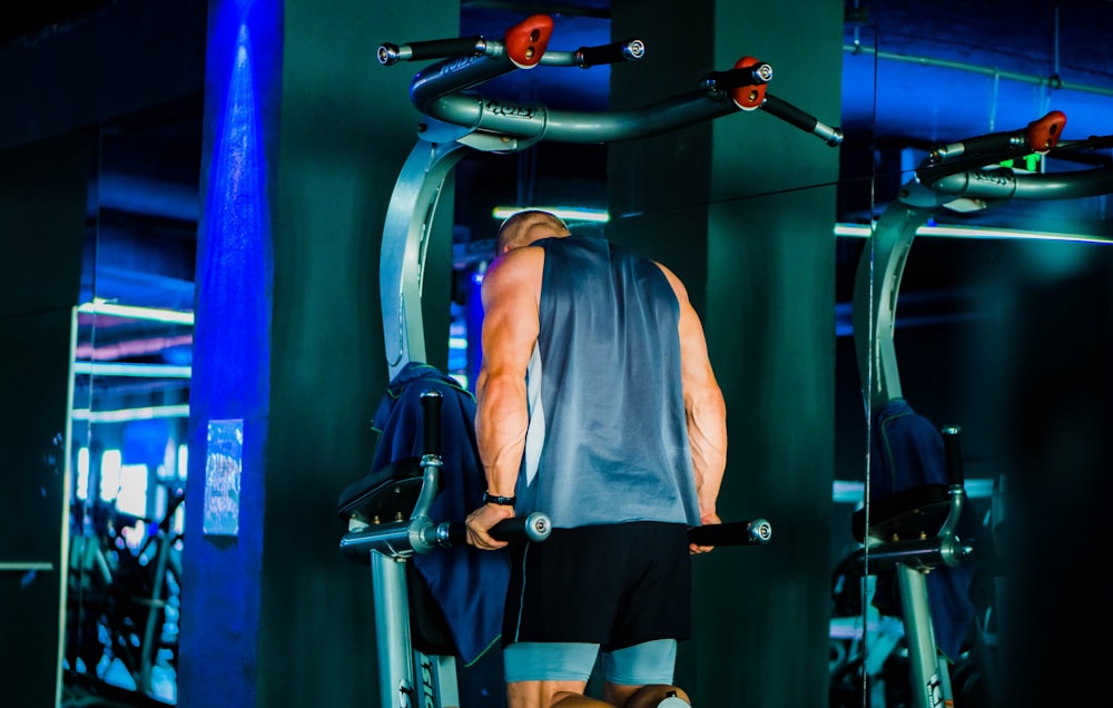 a man standing on a machine in a gym
