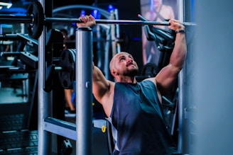 a man doing a pull up on a bar in a gym