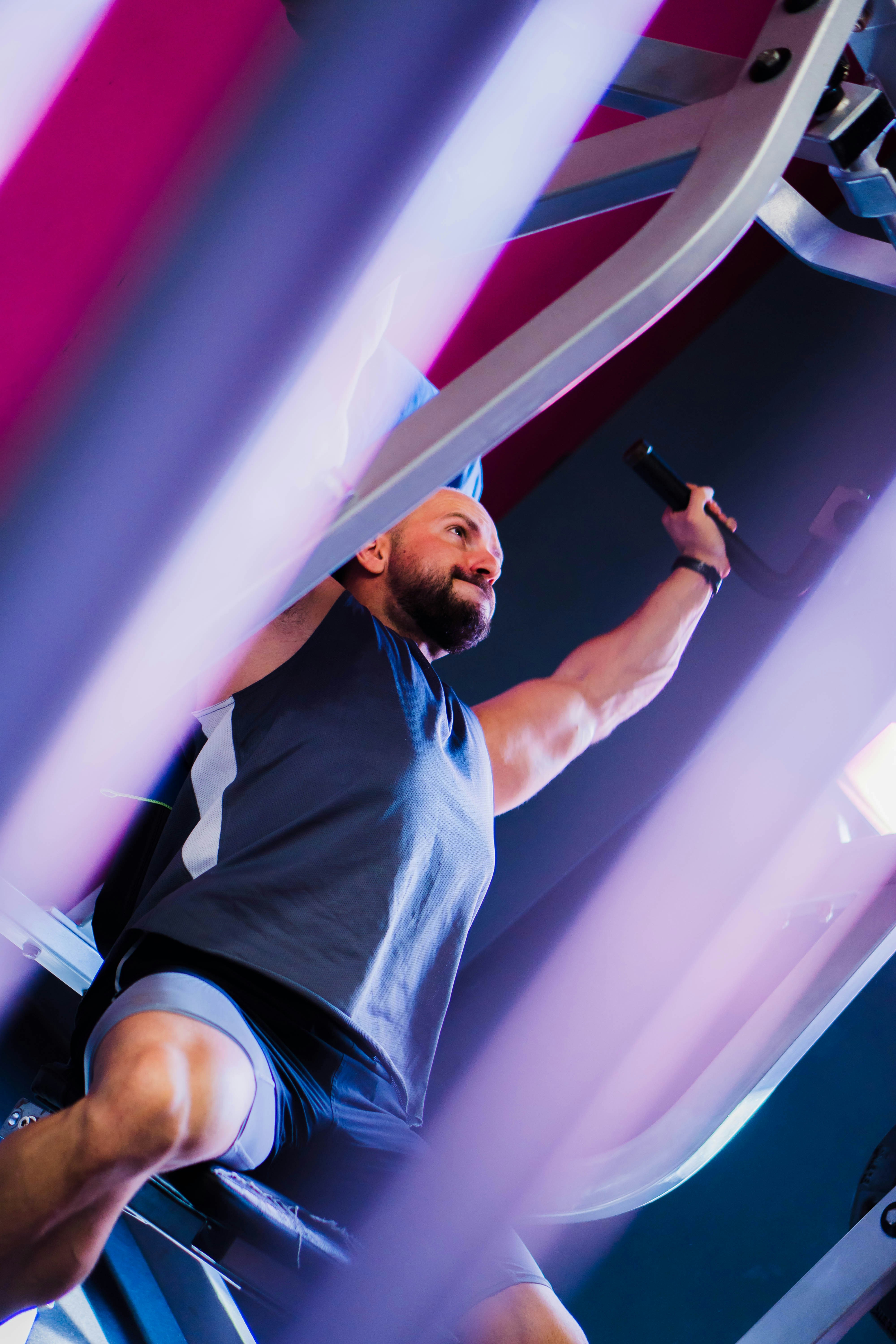 a man in a gym holding a barbell