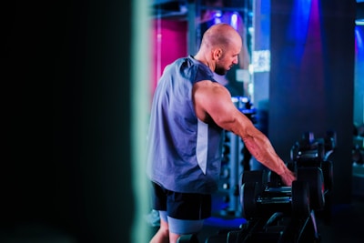 Rohan demonstrating a dynamic hybrid workout in a sleek gym setting with electric blue accents.