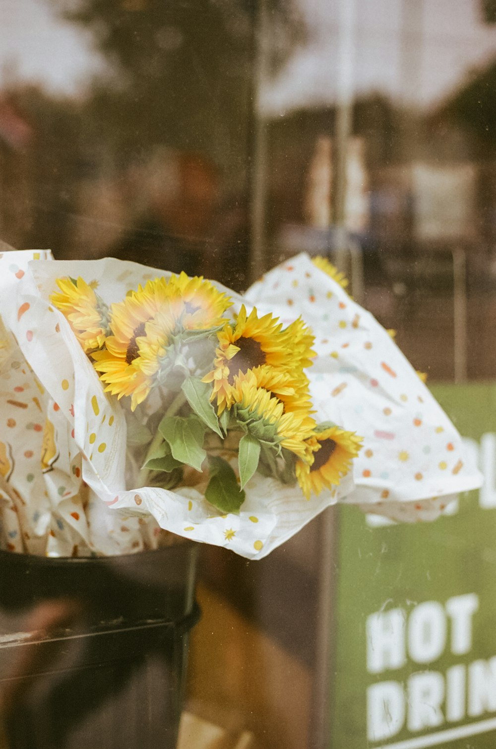 a bunch of sunflowers are wrapped in a paper