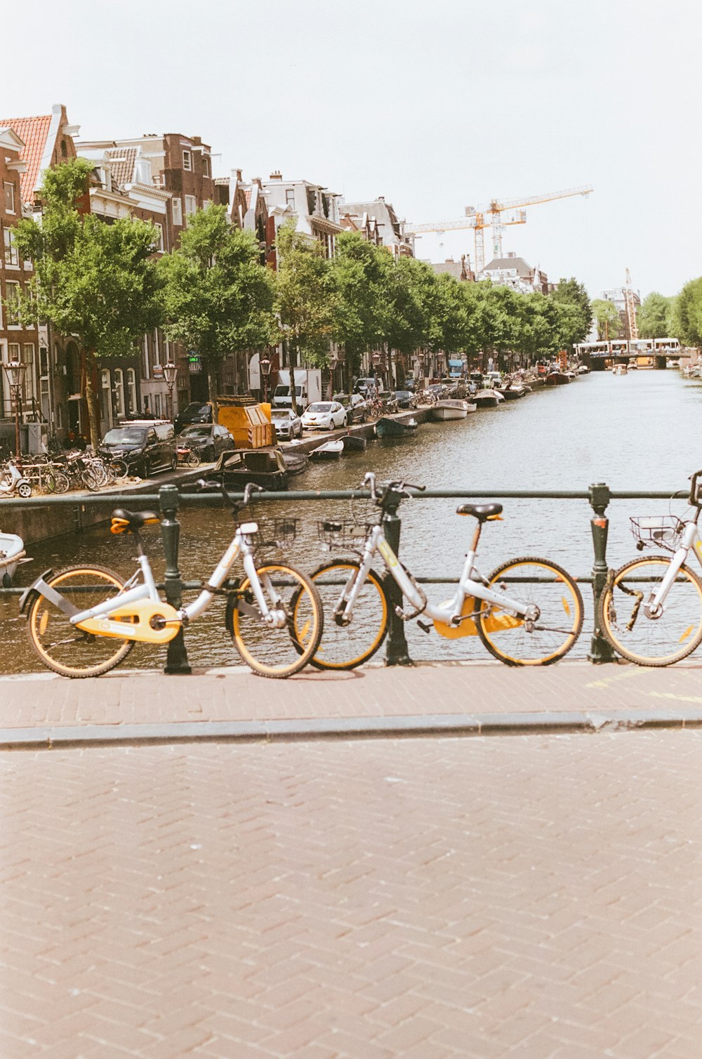 a row of bikes parked next to each other on a bridge