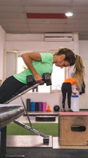 a woman in a gym doing exercises on a rowing machine