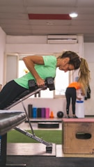 A person performing strength training exercises guided by an online coach.