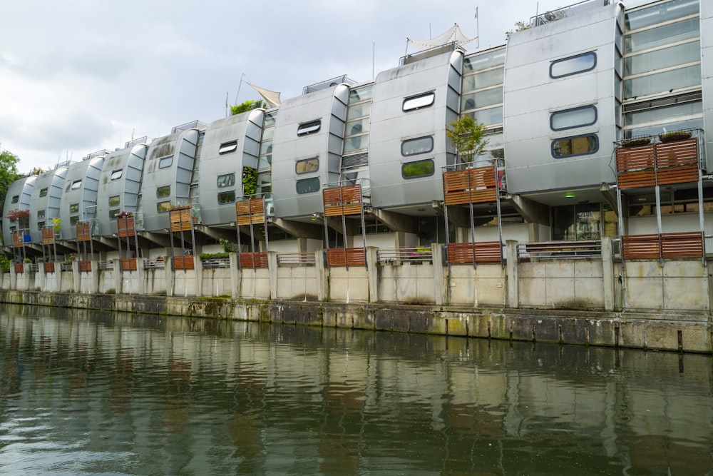 a row of apartment buildings next to a body of water