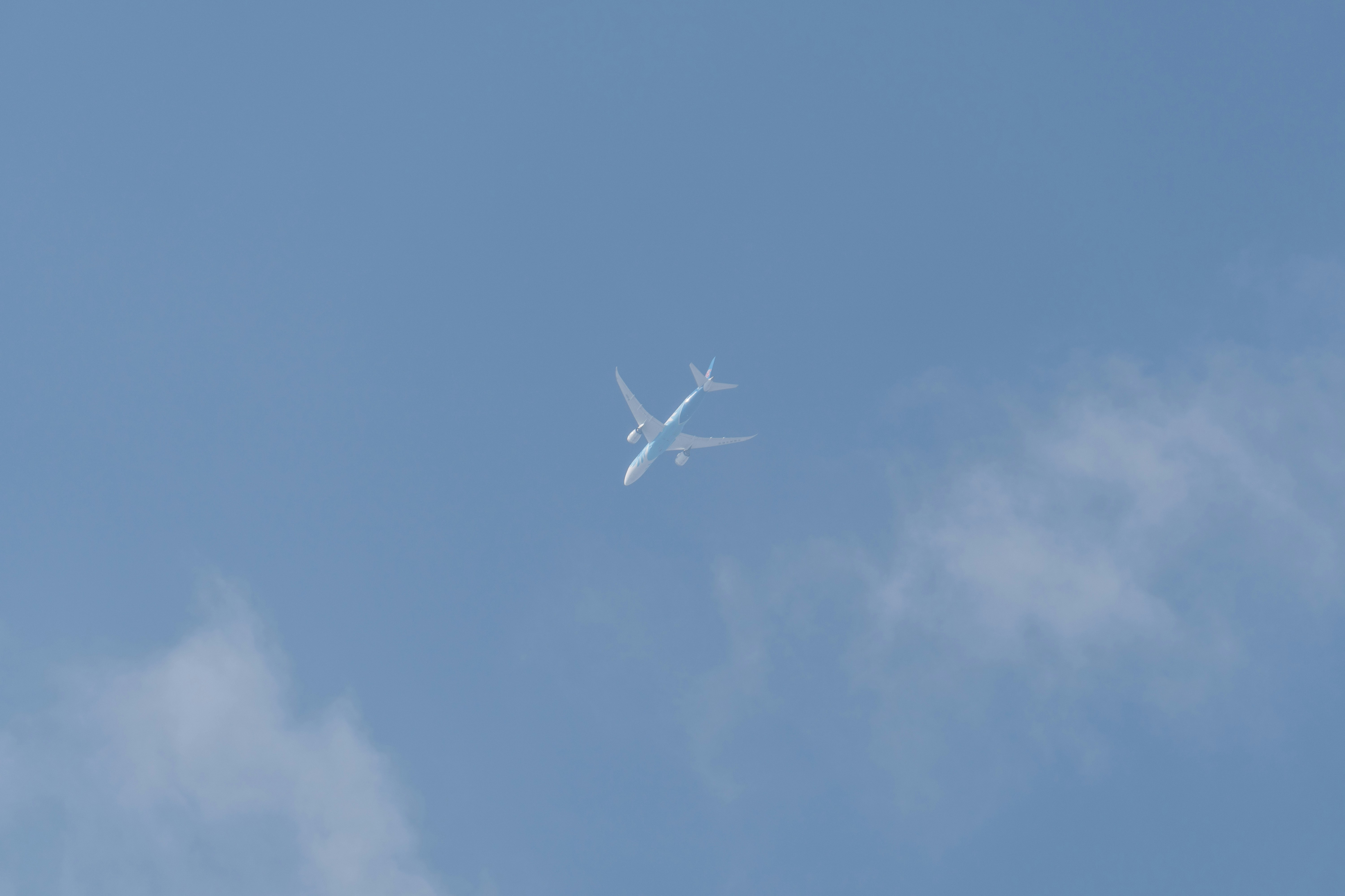 an airplane is flying high in the sky, 