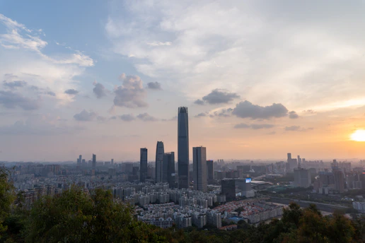 A panoramic view of the Sky Gardens project at sunset, highlighting the sleek towers and lush rooftop gardens.