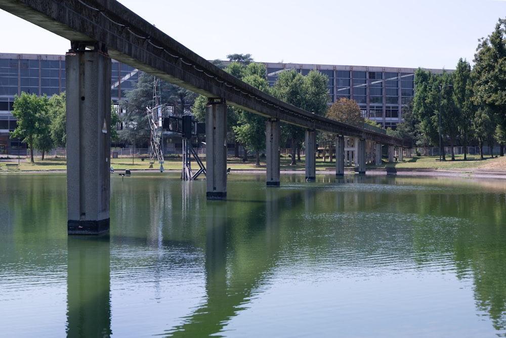 a bridge over a body of water with a building in the background