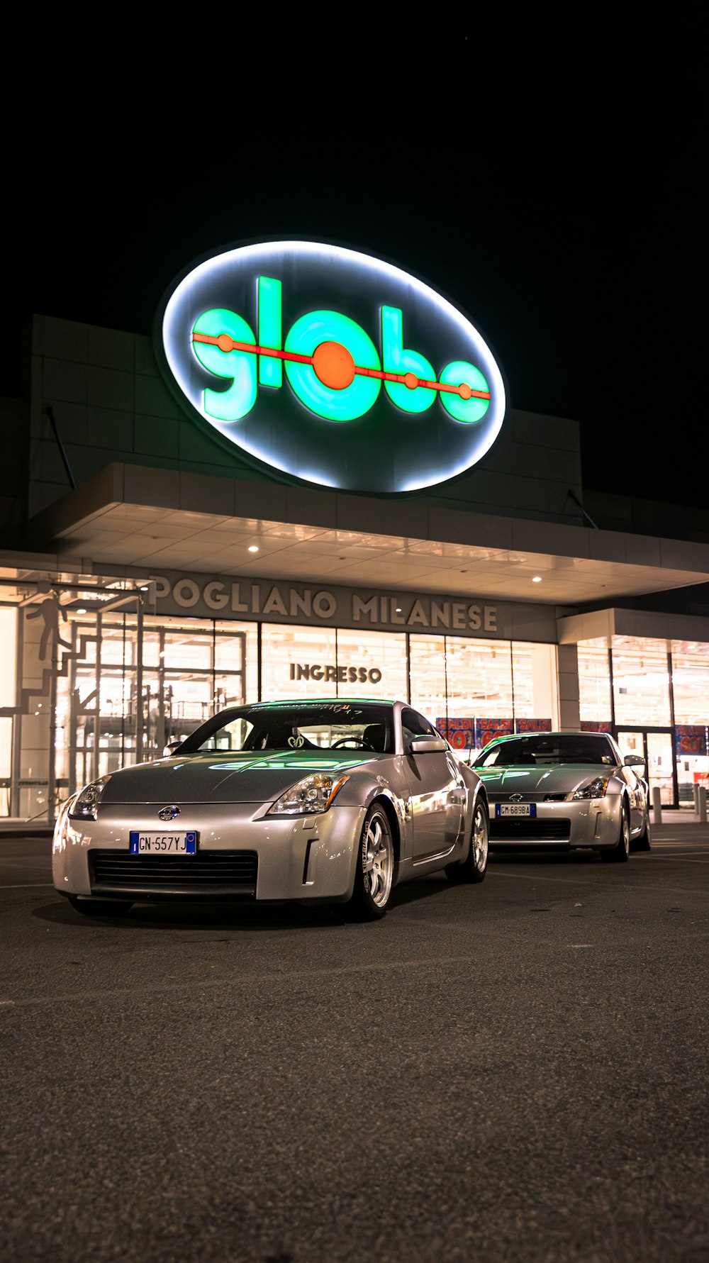 a car parked in front of a store at night