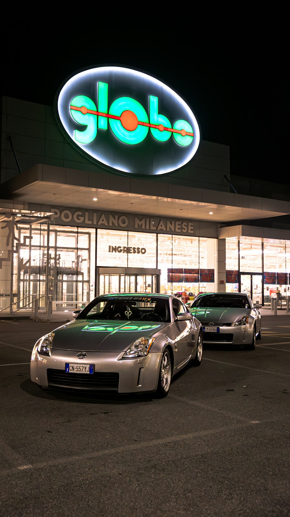 two cars are parked in front of a store