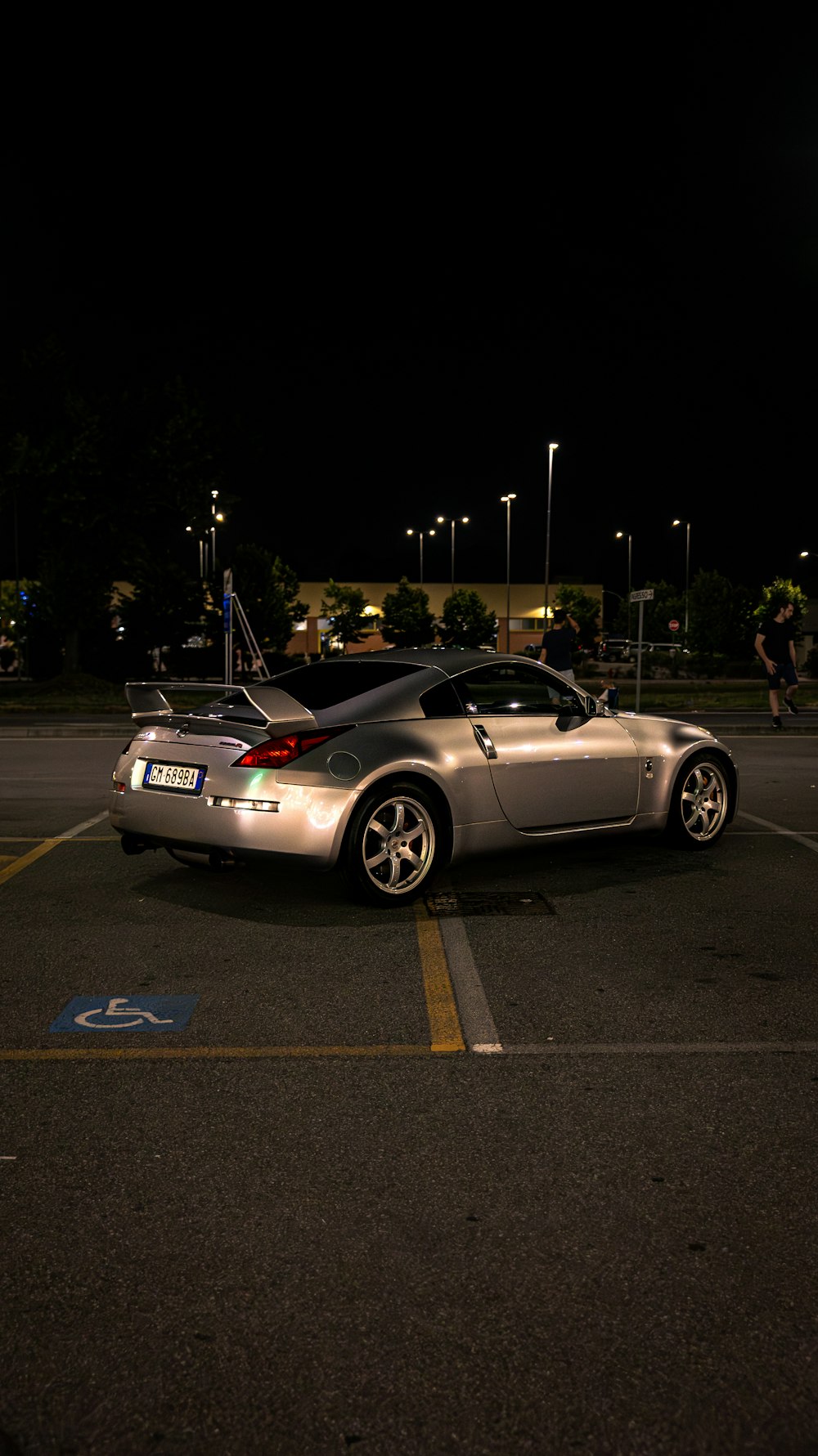 a silver sports car parked in a parking lot