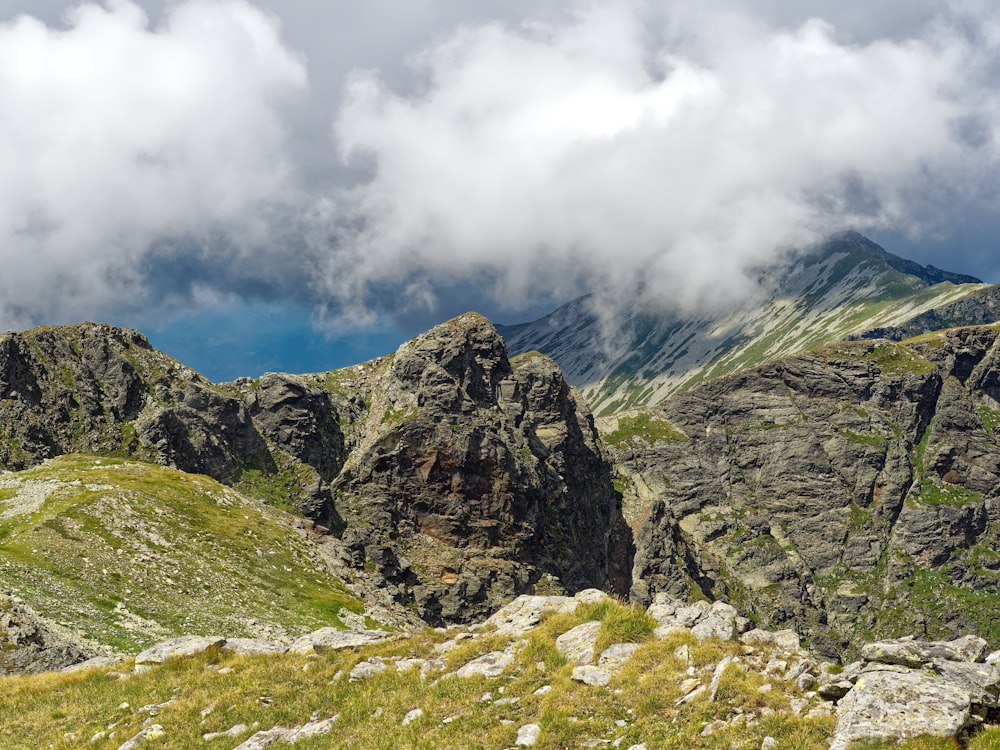 a view of a mountain range with clouds in the sky