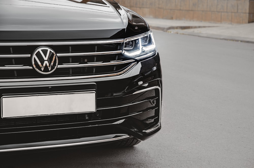 a close up of the front of a black volkswagen suv