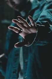 a man holding his hand out in front of him