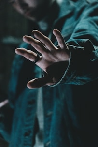 a man holding his hand out in front of him