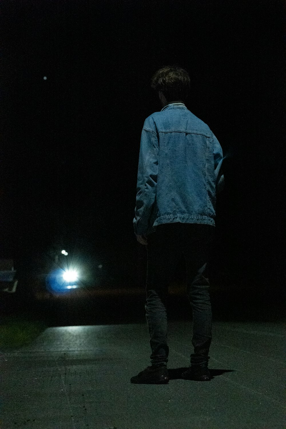 a man walking down a street at night