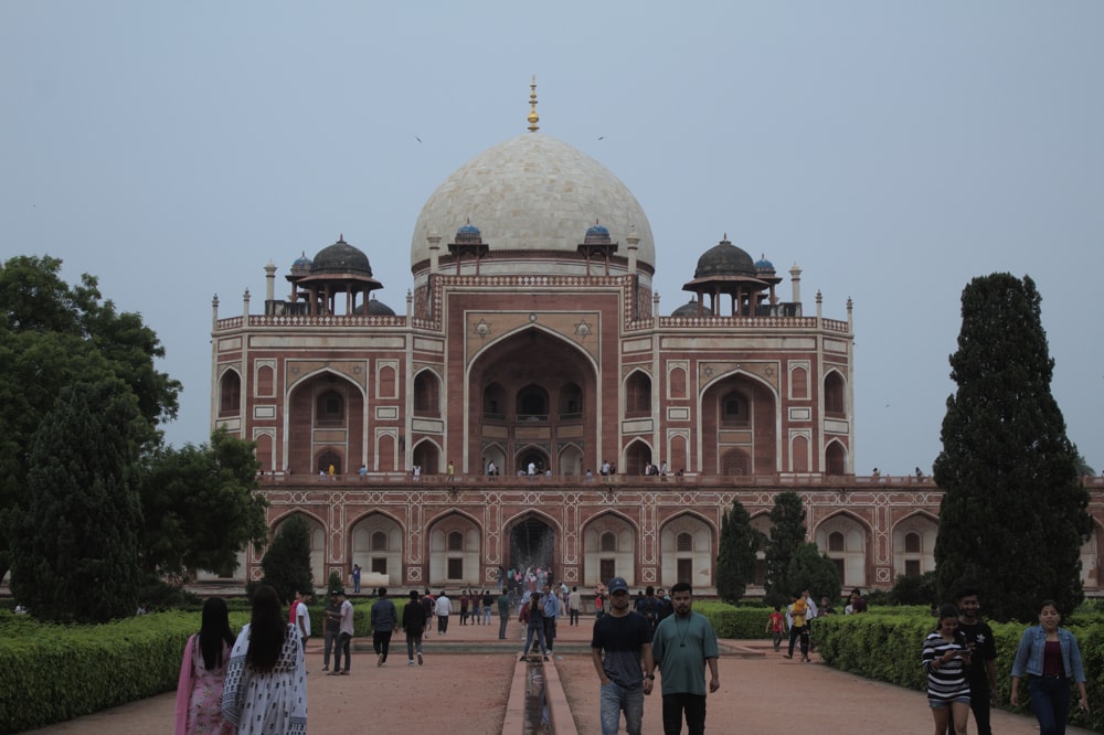 a group of people walking in front of a building