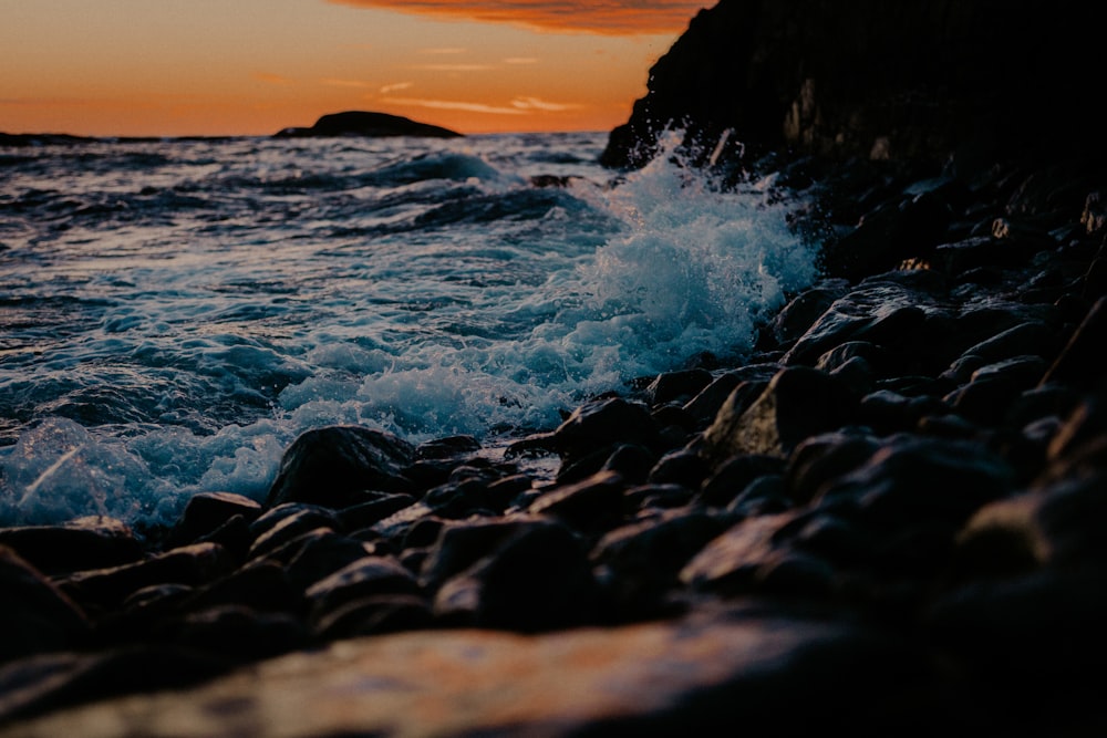 a rocky shore with waves crashing against the rocks