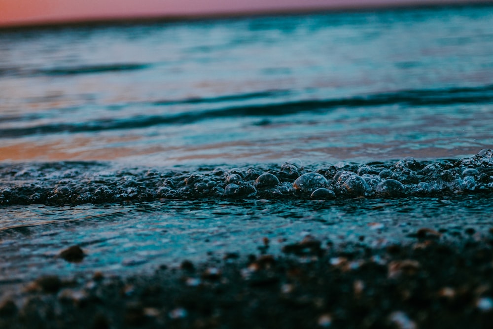 a close up of a wave coming in to the shore