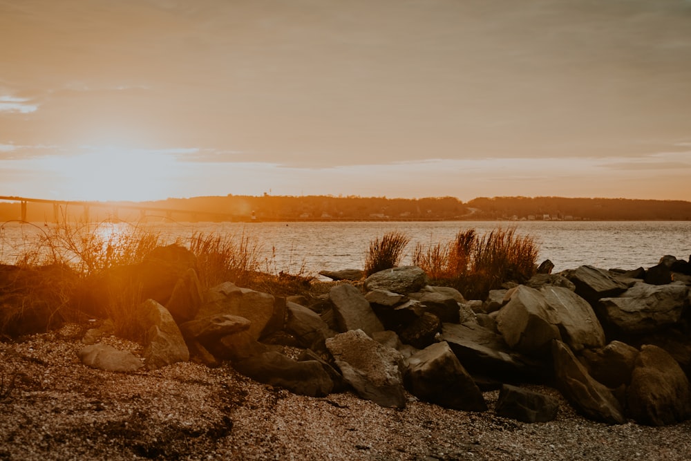 the sun is setting over a body of water