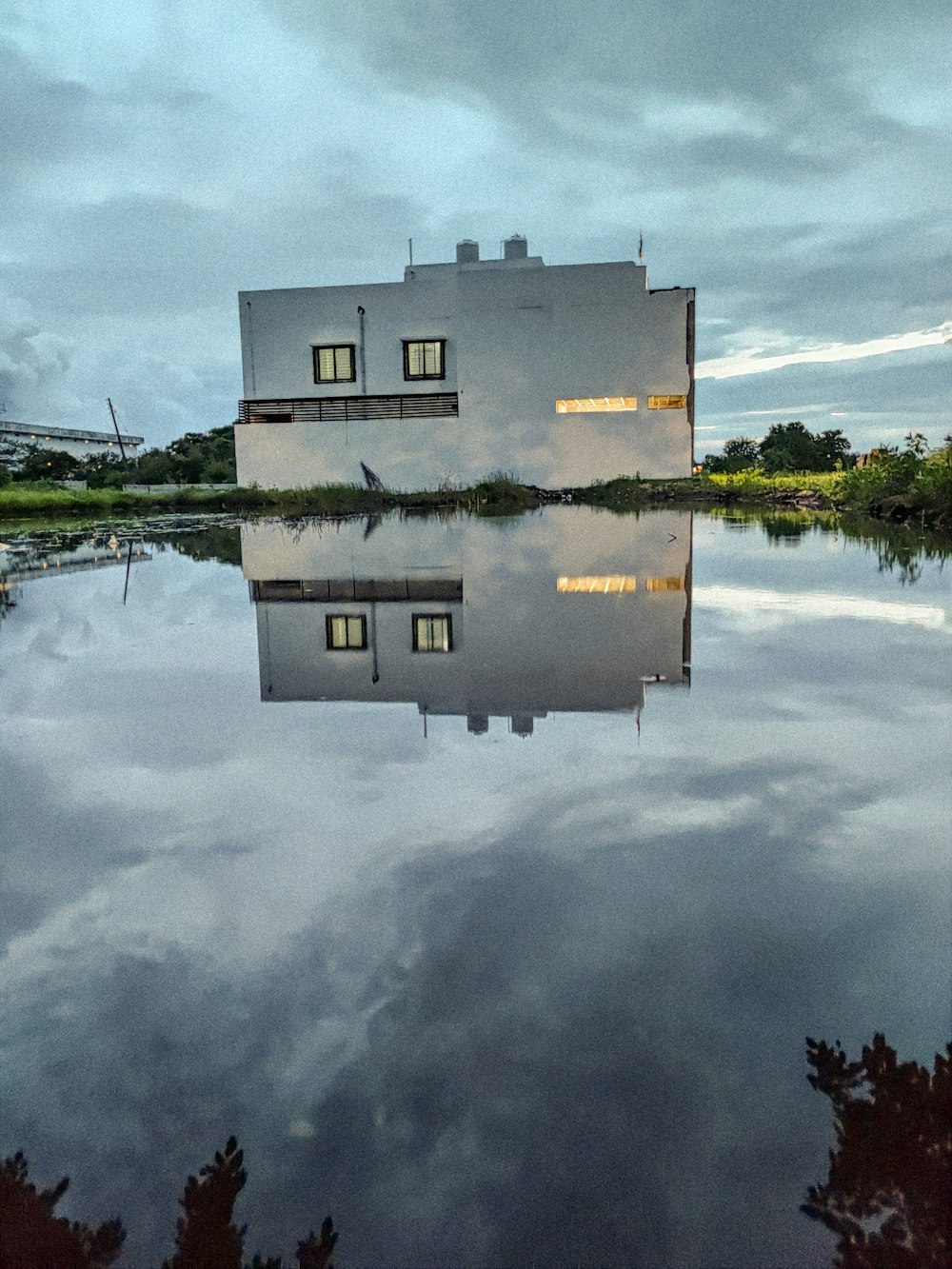 a white house sitting on top of a body of water