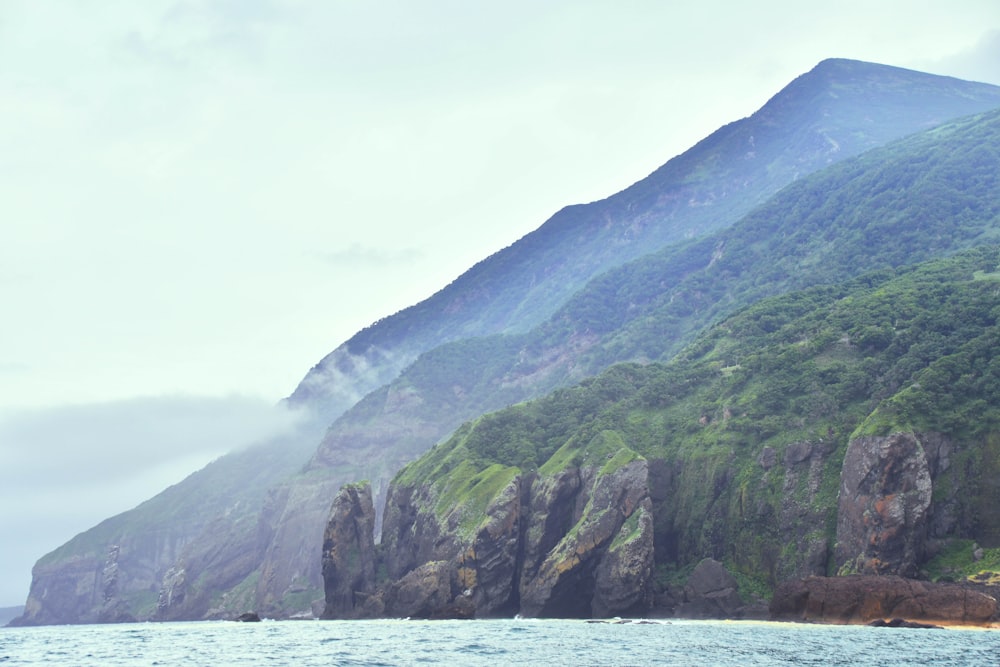 a large body of water with a mountain in the background