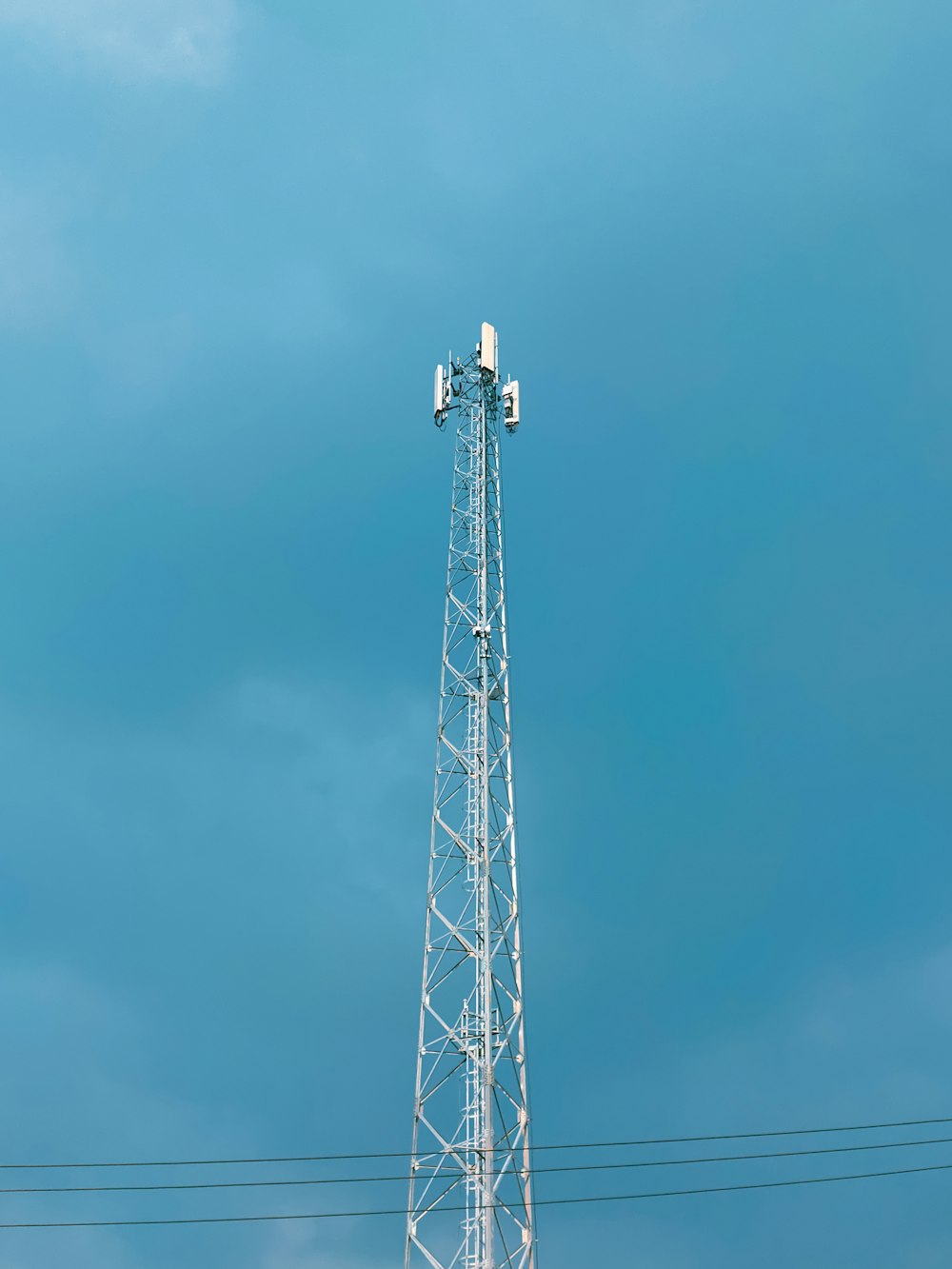 a cell phone tower with a blue sky in the background