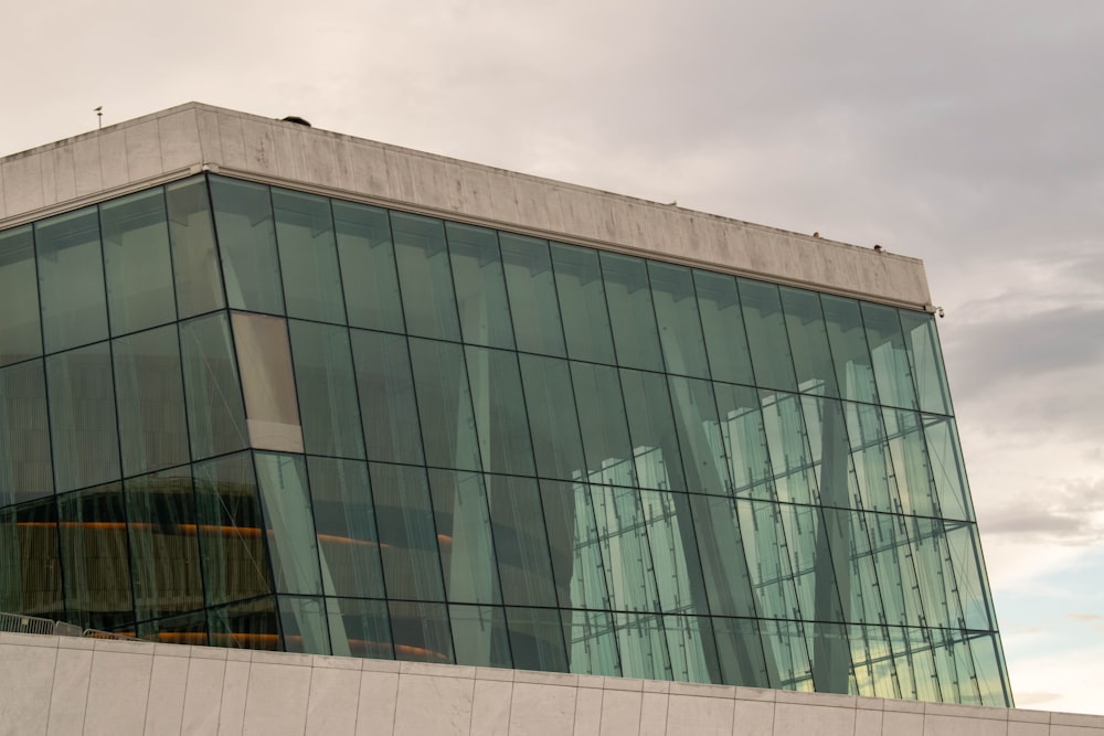 a large glass building with a sky background