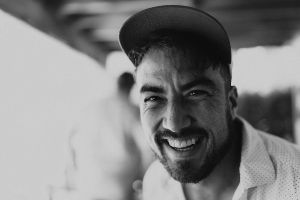 a black and white photo of a smiling man