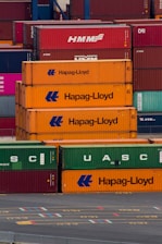 a bunch of cargo containers stacked on top of each other
