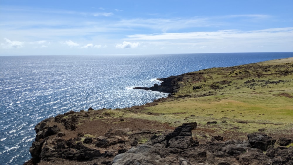 a view of the ocean from the top of a hill