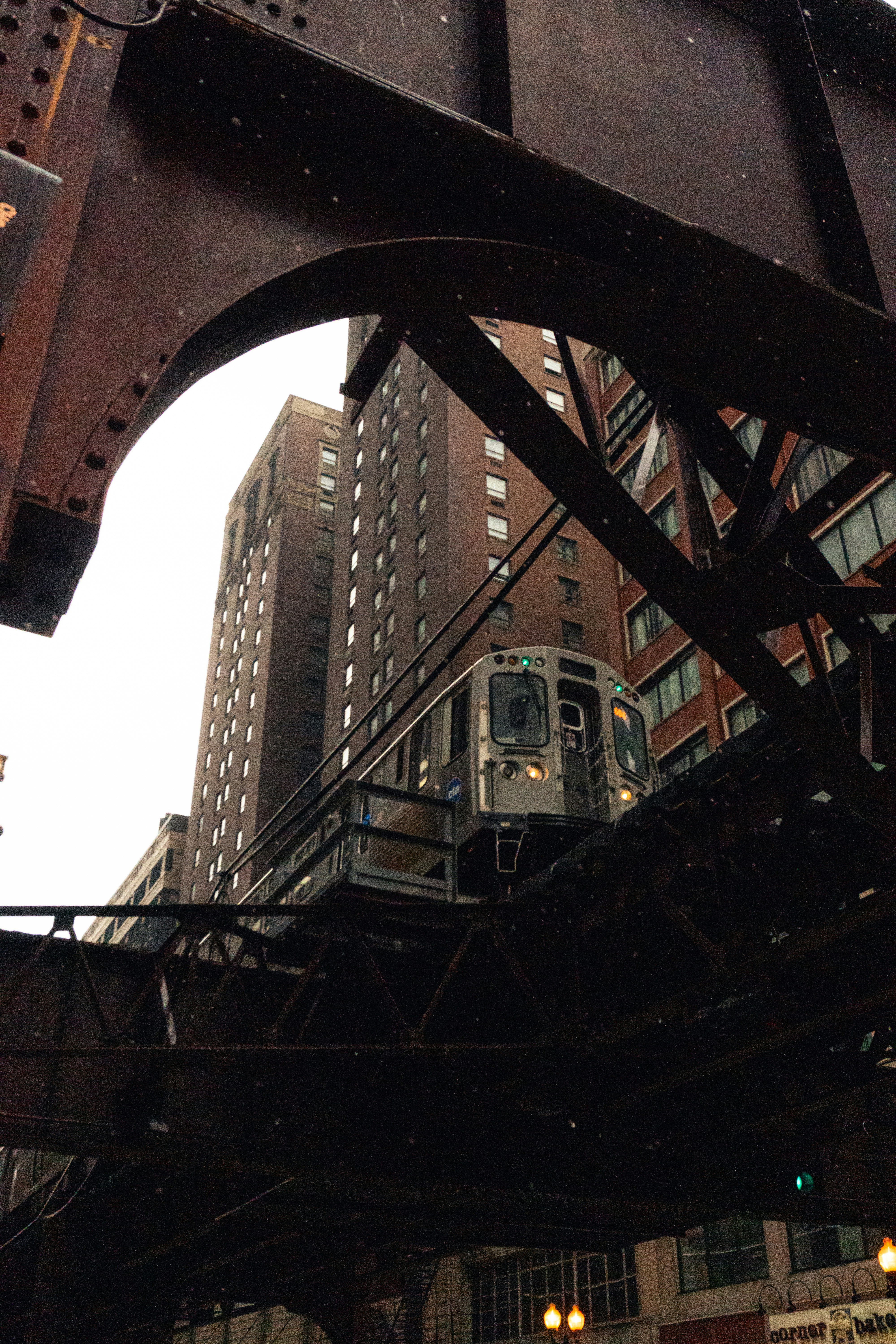 a train traveling over a bridge next to tall buildings
