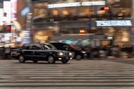 A taxi on a busy street during the evening.