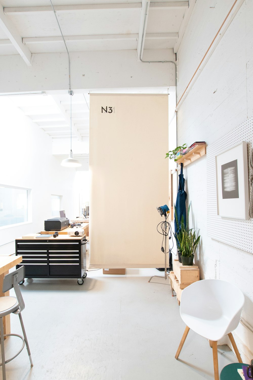 a room with a white wall and a white chair