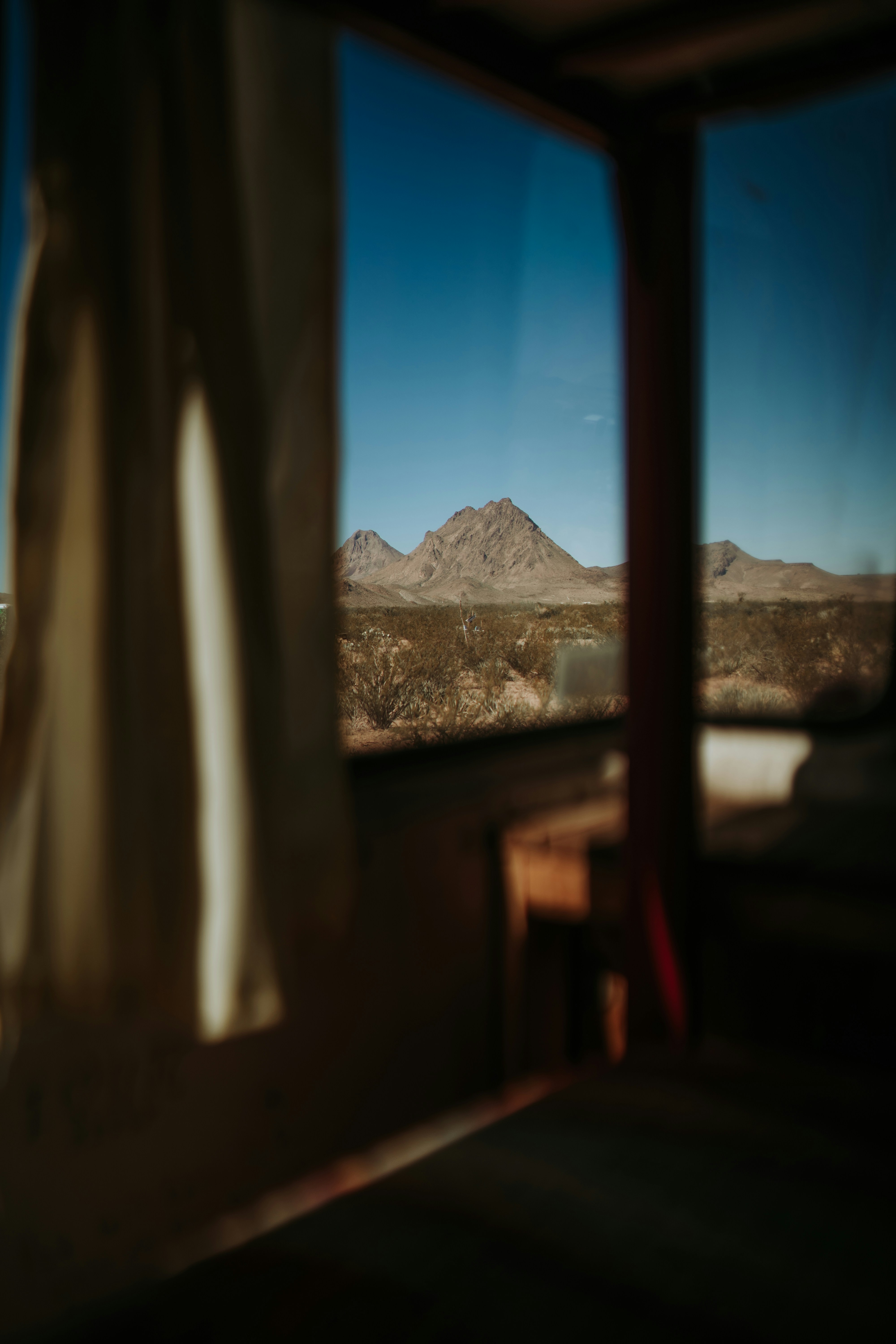 A bedroom with a view of a mountain range