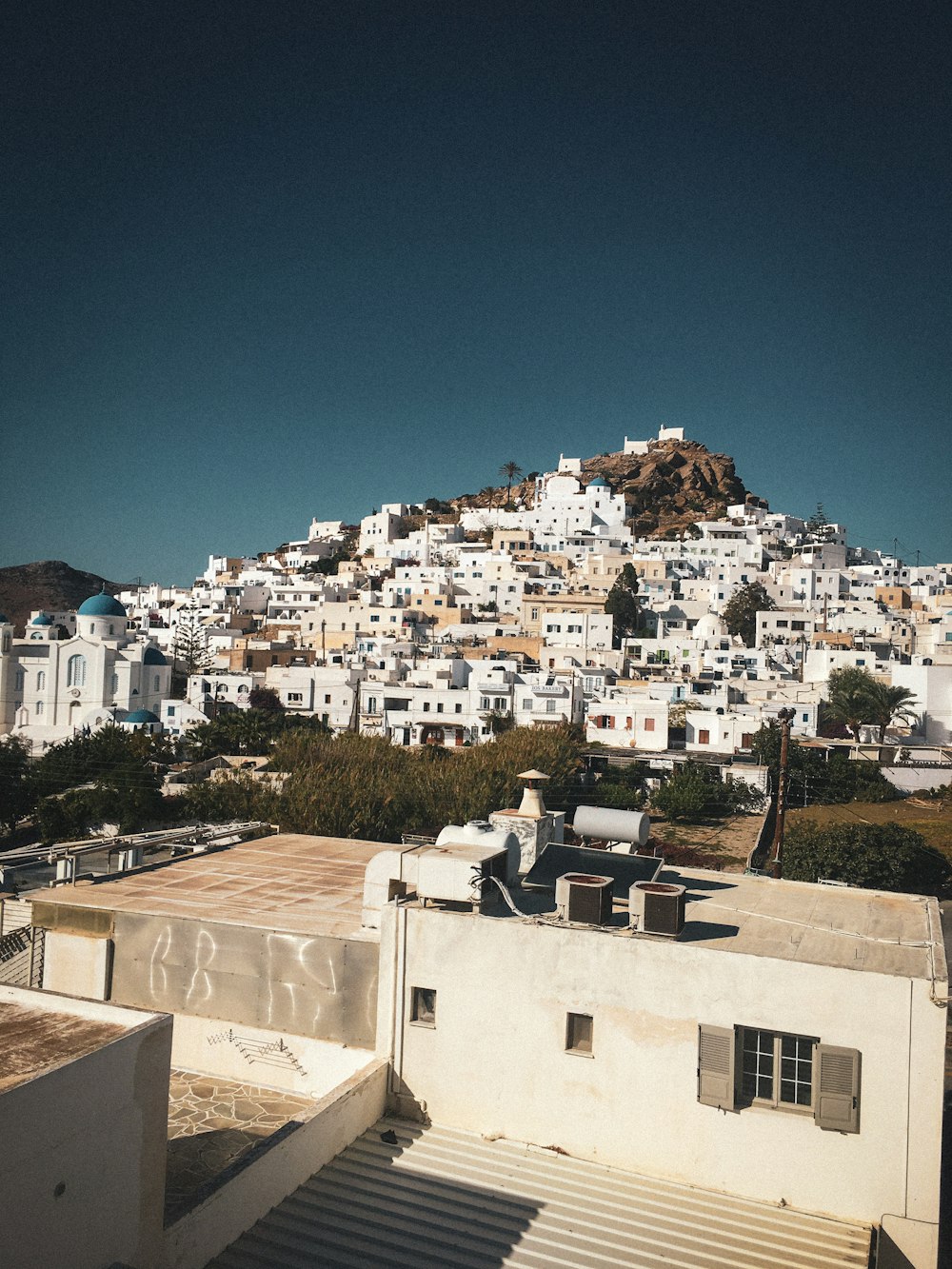 a view of a city with a hill in the background