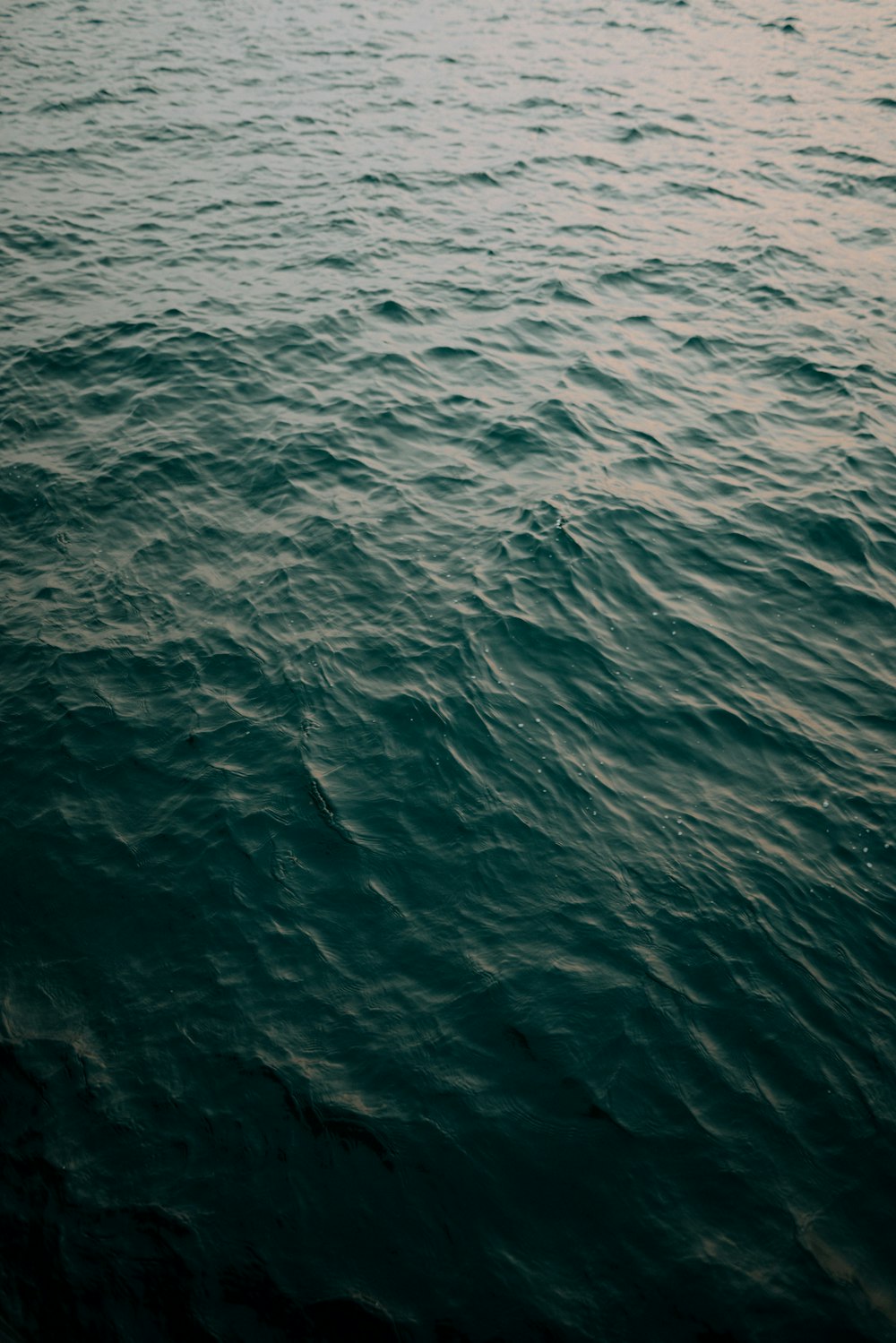 a large body of water with a boat in the distance