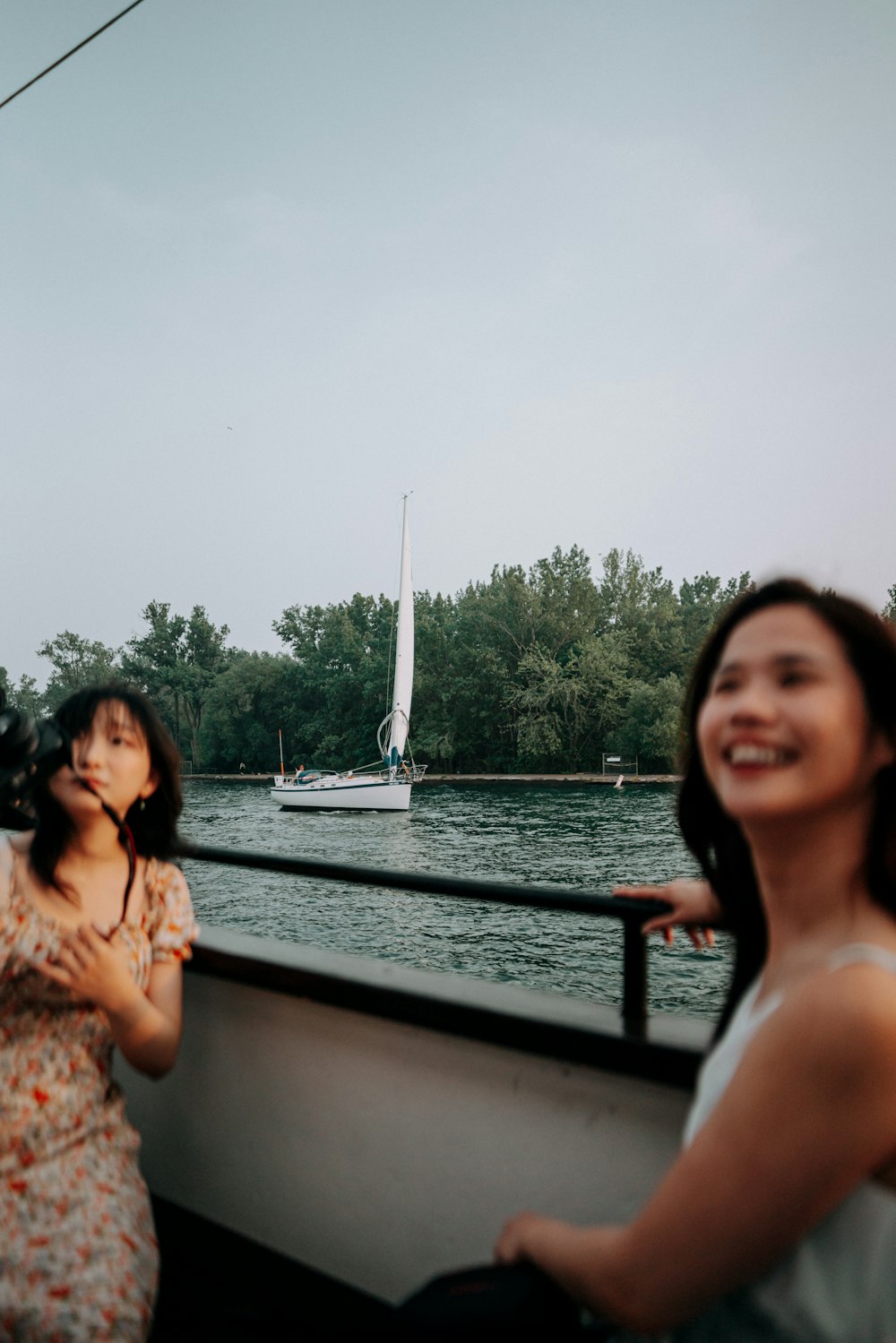 two women standing on a boat in the water