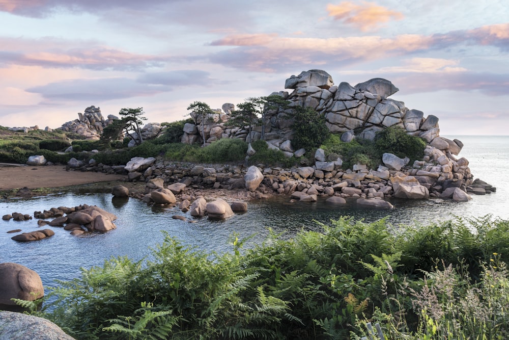 a small island with rocks in the middle of a body of water