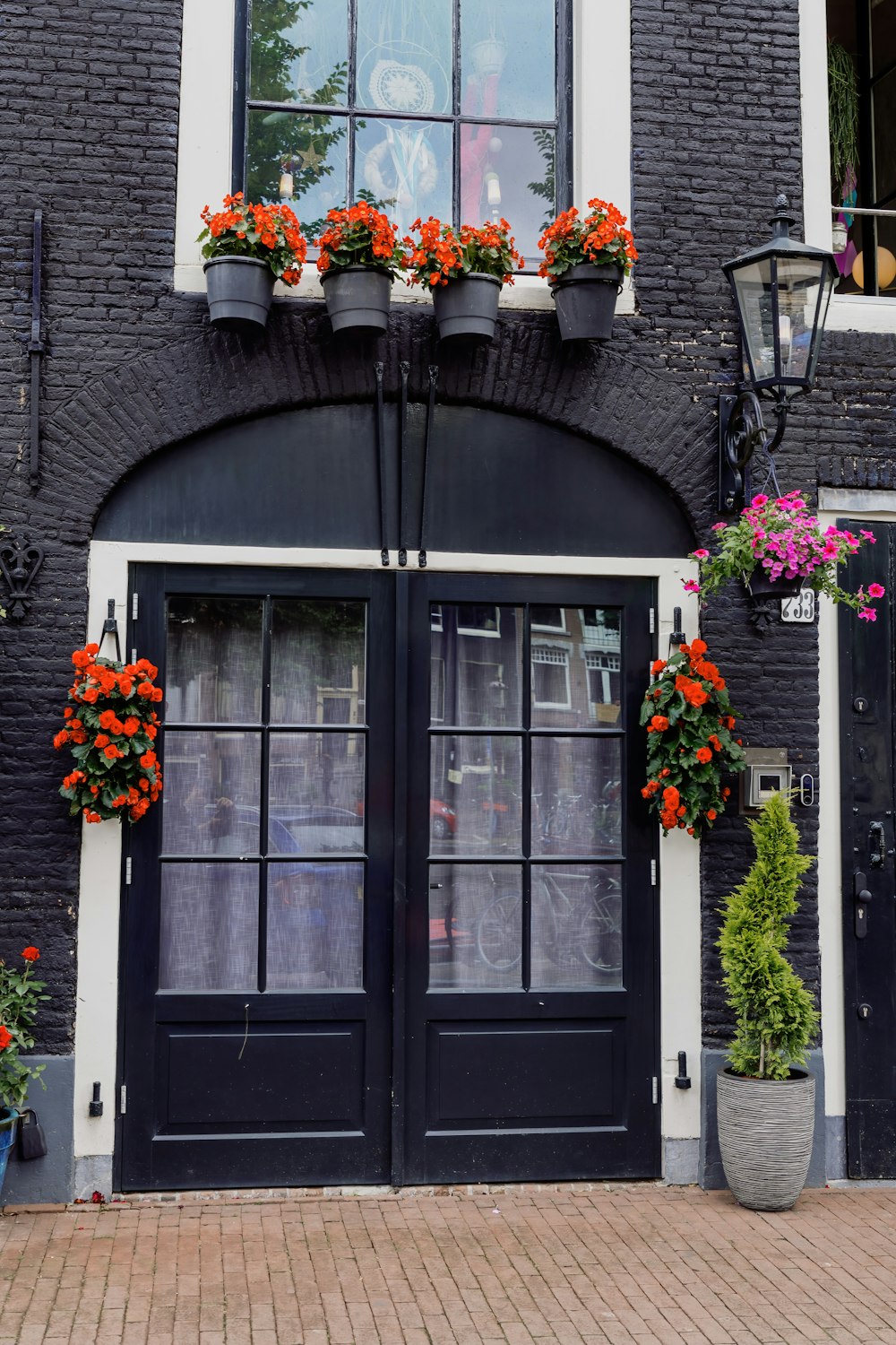 a building with a bunch of flowers on the windows