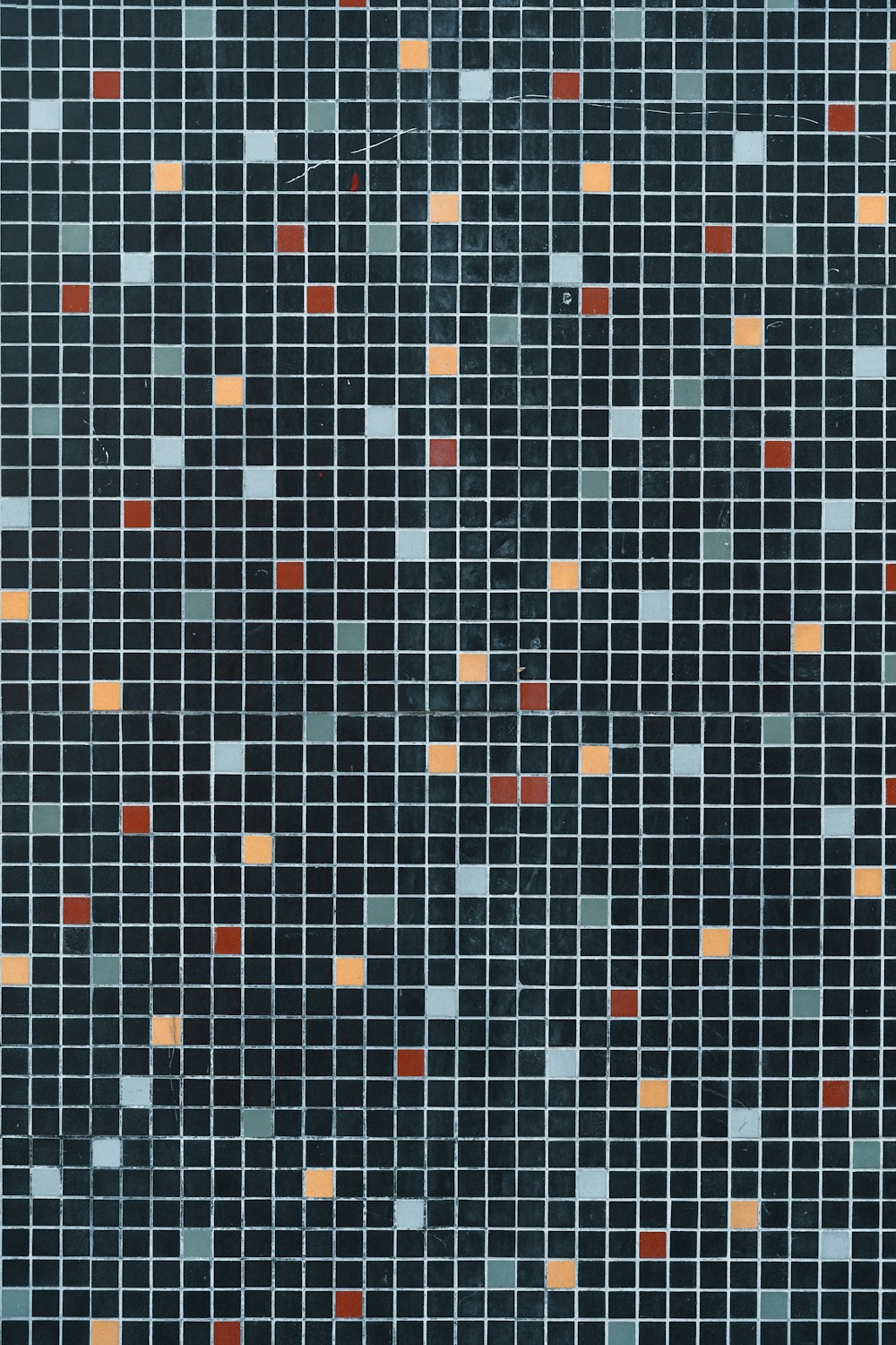 a blue and orange mosaic tile pattern with small squares