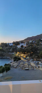 A cozy beachfront villa illuminated warmly at dusk, inviting relaxation.
