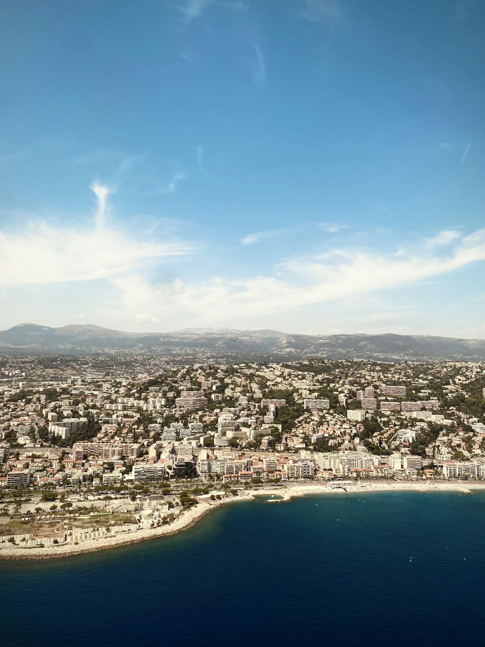 an aerial view of a city and a body of water